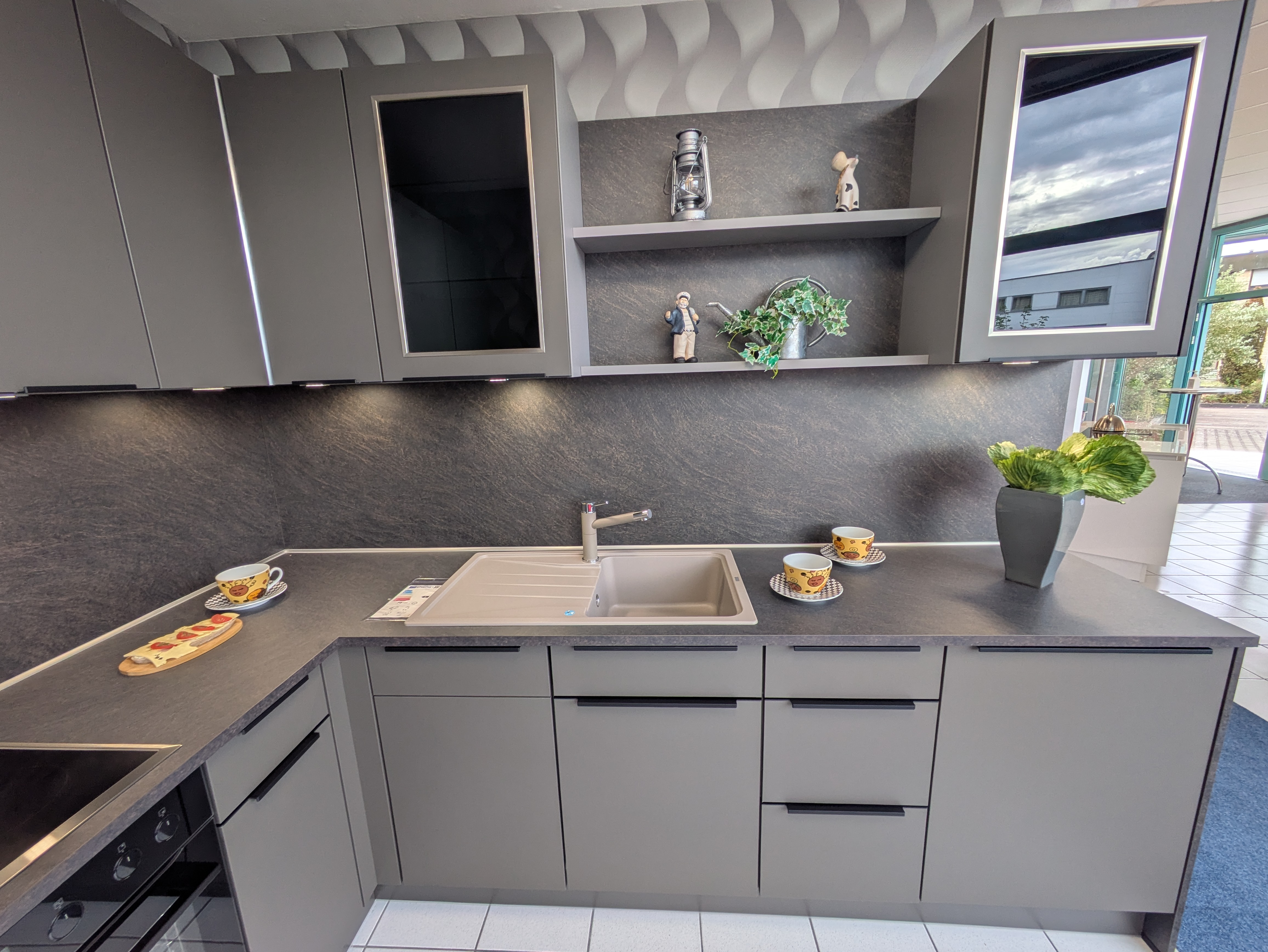 Tolle, moderne Küche in Vulkanbraun mit schwarzen Griffleisten und Rauchglas