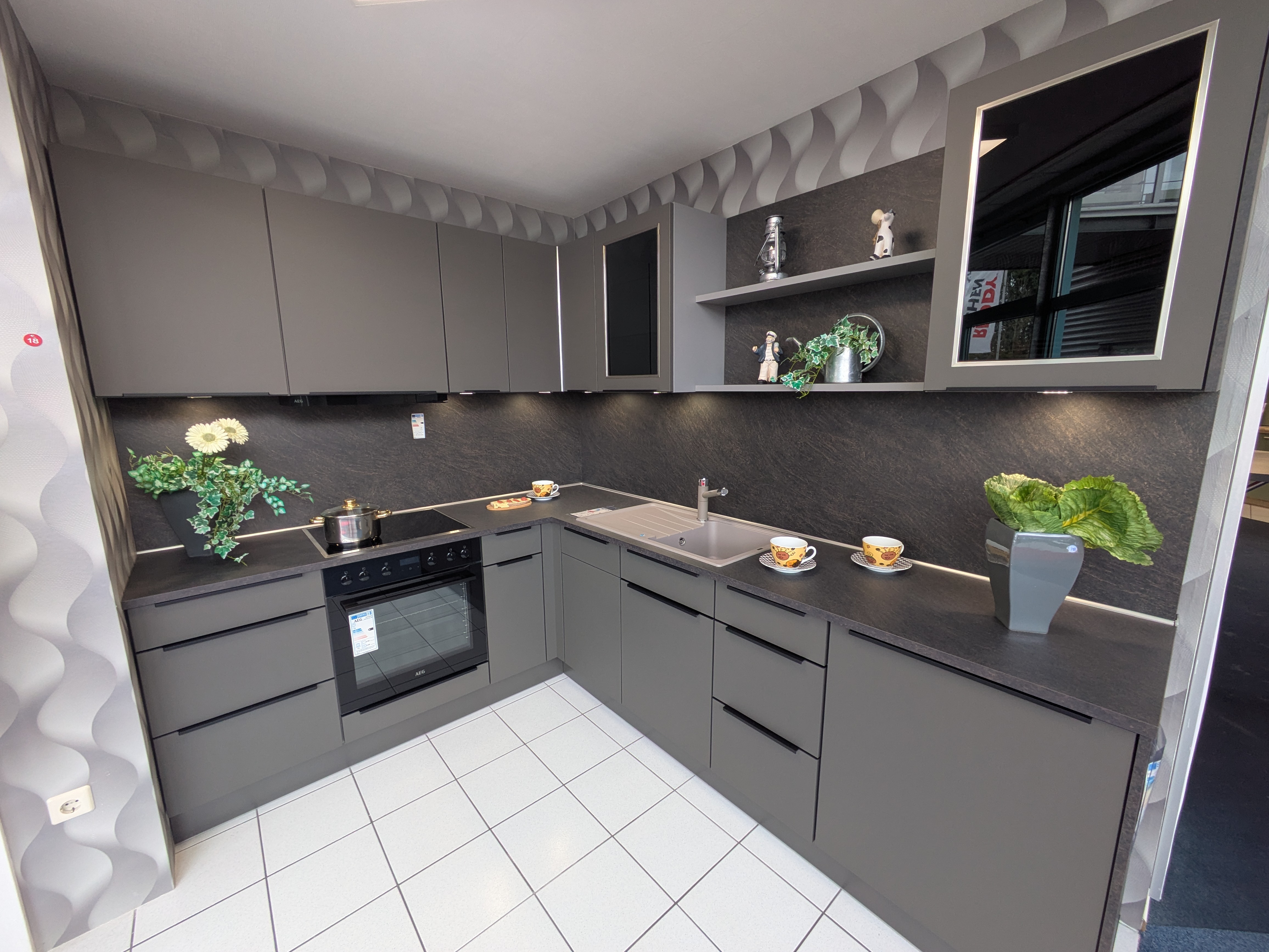 Tolle, moderne Küche in Vulkanbraun mit schwarzen Griffleisten und Rauchglas