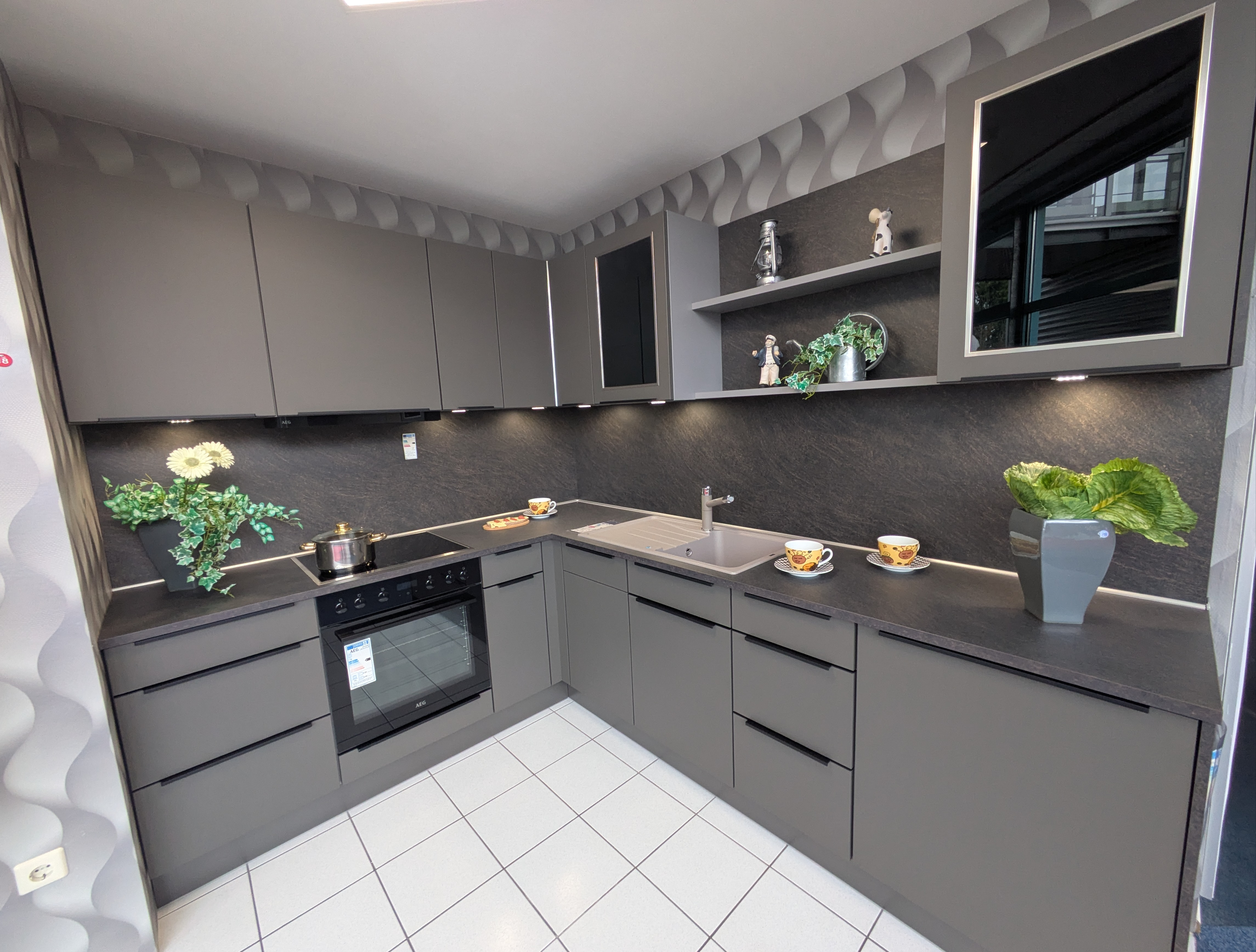 Tolle, moderne Küche in Vulkanbraun mit schwarzen Griffleisten und Rauchglas