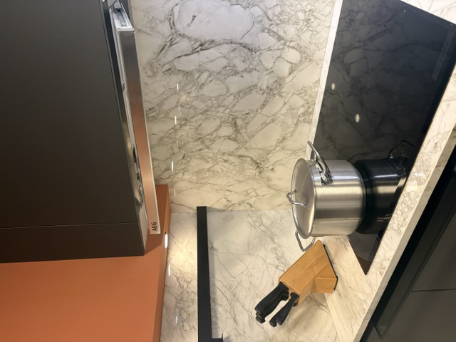 Minimalistische moderne keuken met een grafiet meubel en een keramiek marmer look, glanzend blad